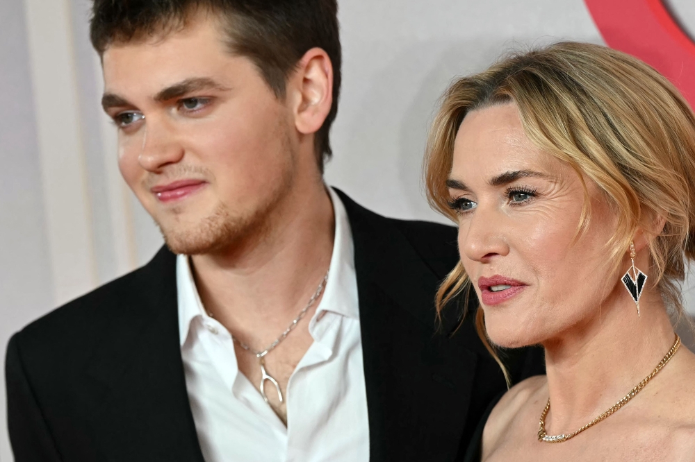 British actress Kate Winslet and her son US-English actor and writer Joe Anders pose on the red carpet upon arrival to attend the world premiere of the film 