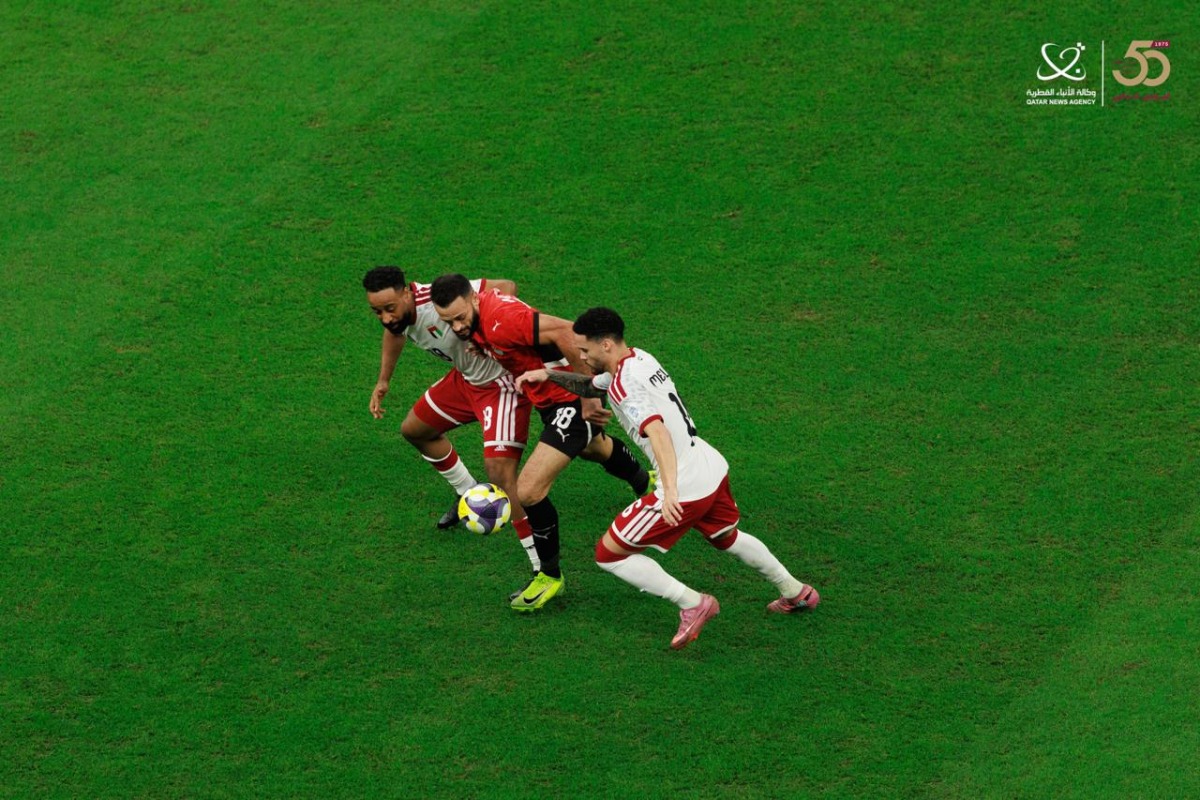 Egypt's Marwan Hamdy (centre) is challenged by two UAE players.