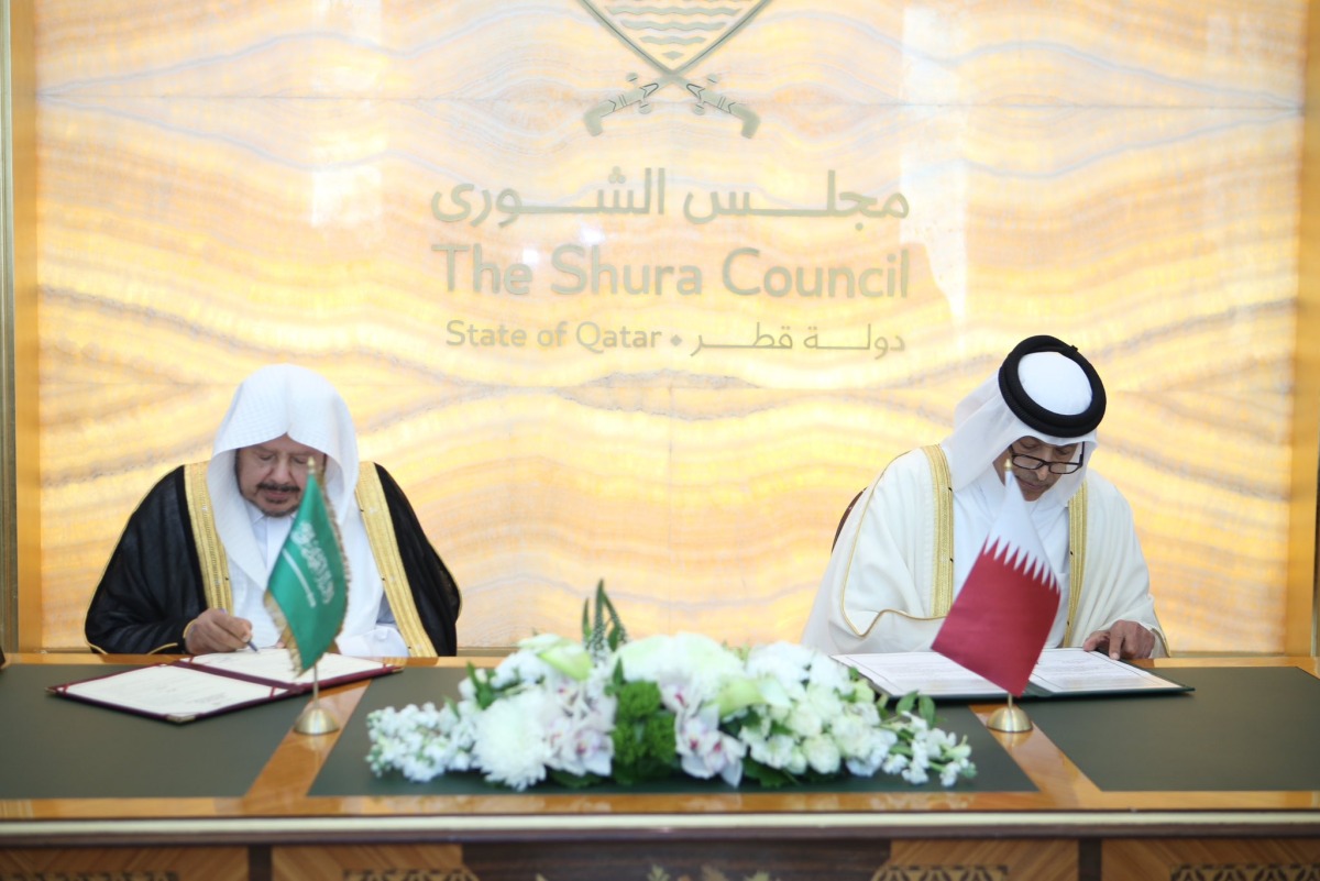 Speaker of the Shura Council H E Hassan bin Abdullah Al Ghanim and Speaker of the Shura Council of Saudi Arabia H E Sheikh Dr. Abdullah bin Mohammed bin Ibrahim Al Sheikh signing an agreement to enhance cooperation between the two councils.
