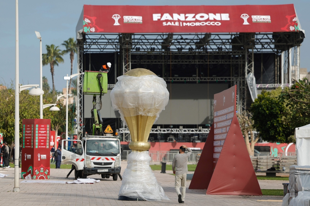Workers put the finishing touches on the fanzone, in the Souissi district of Rabat, Morocco on December 20, 2025, ahead of the start of the Africa Cup of Nations (CAN) football tournament. (Photo by Abdel Majid BZIOUAT / AFP)