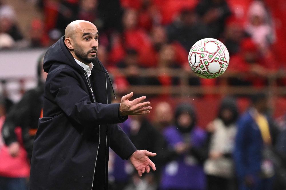 Morocco's head coach Walid Regragui throws a ball during the Africa Cup of Nations (CAN) group A football match between Morocco and Comoros at Prince Moulay Abdellah Stadium in Rabat on December 21, 2025. (Photo by Sebastien Bozon / AFP)