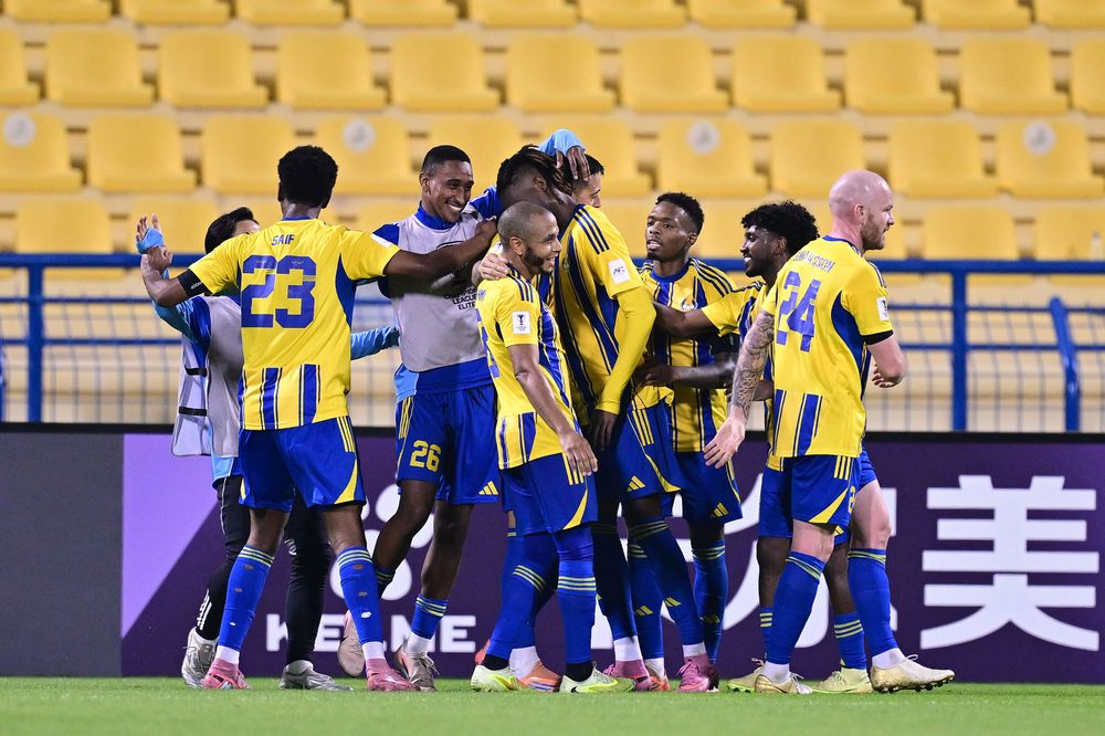 Al Gharafa players celebrate after Seydou Sano scored the late winner.
