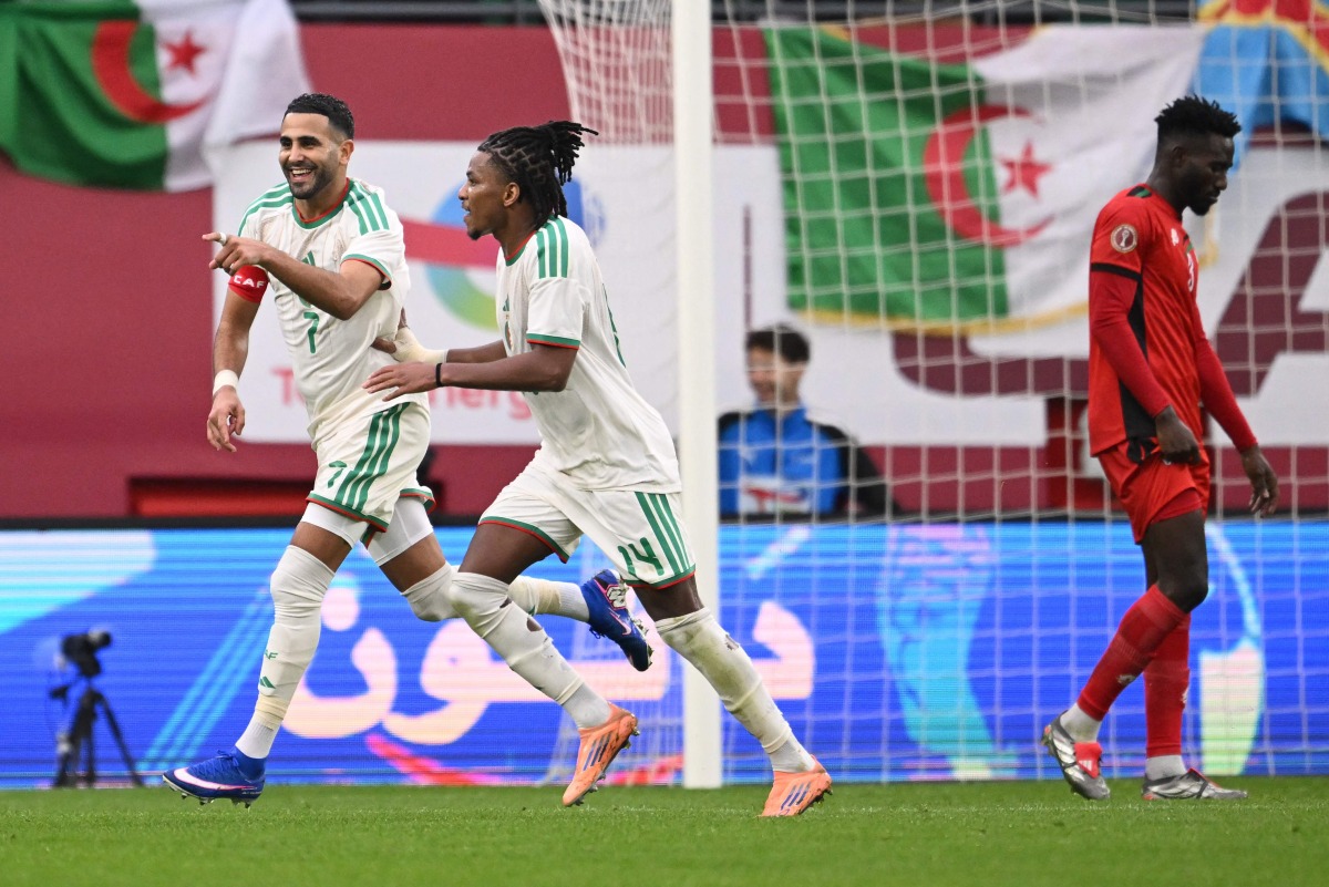 Algeria's forward #7 Riyad Mahrez (L) celebrates scoring the team's second goal with Algeria's midfielder #14 Hicham Boudaoui during the Africa Cup of Nations (CAN) Group E football match between Algeria and Sudan at Moulay Hassan Stadium in Rabat on December 24, 2025. (Photo by SEBASTIEN BOZON / AFP)
