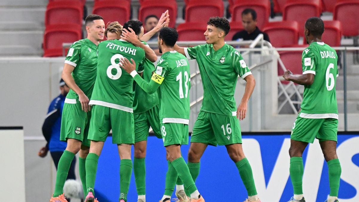 Al Ahli players celebrate during the match.  