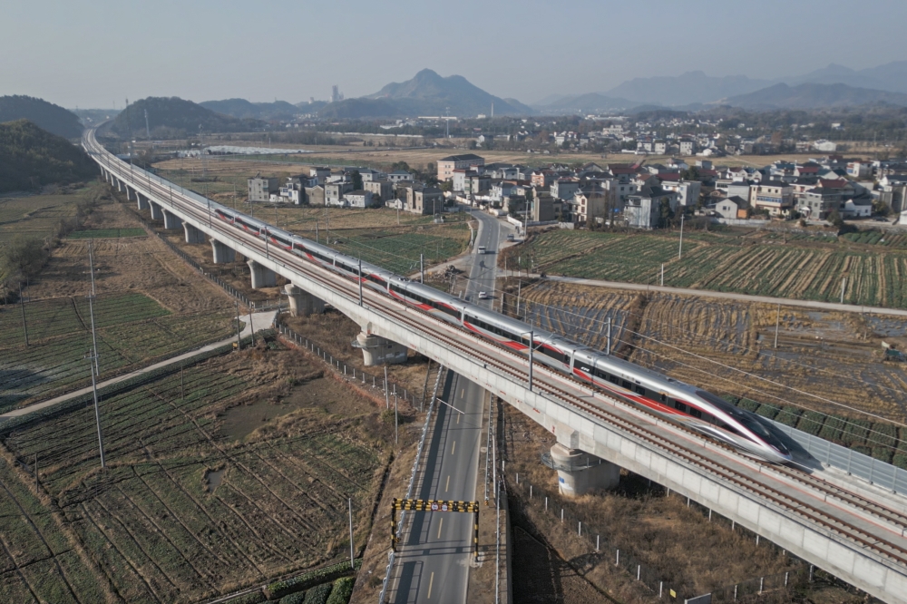 An aerial drone photo taken on Dec. 26, 2025 shows the C3132 passenger train bound for Hangzhou running along the Hangzhou-Quzhou high-speed railway in east China's Zhejiang Province. (Xinhua/Huang Zongzhi)
 
