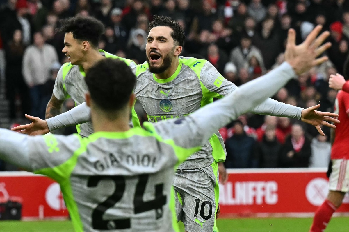 Manchester City's French midfielder 10 Rayan Cherki (C) celebrates after scoring their second goal during the English Premier League football match between Nottingham Forest and Manchester City at The City Ground in Nottingham, central England, on December 27, 2025. (Photo by Ben STANSALL / AFP) /