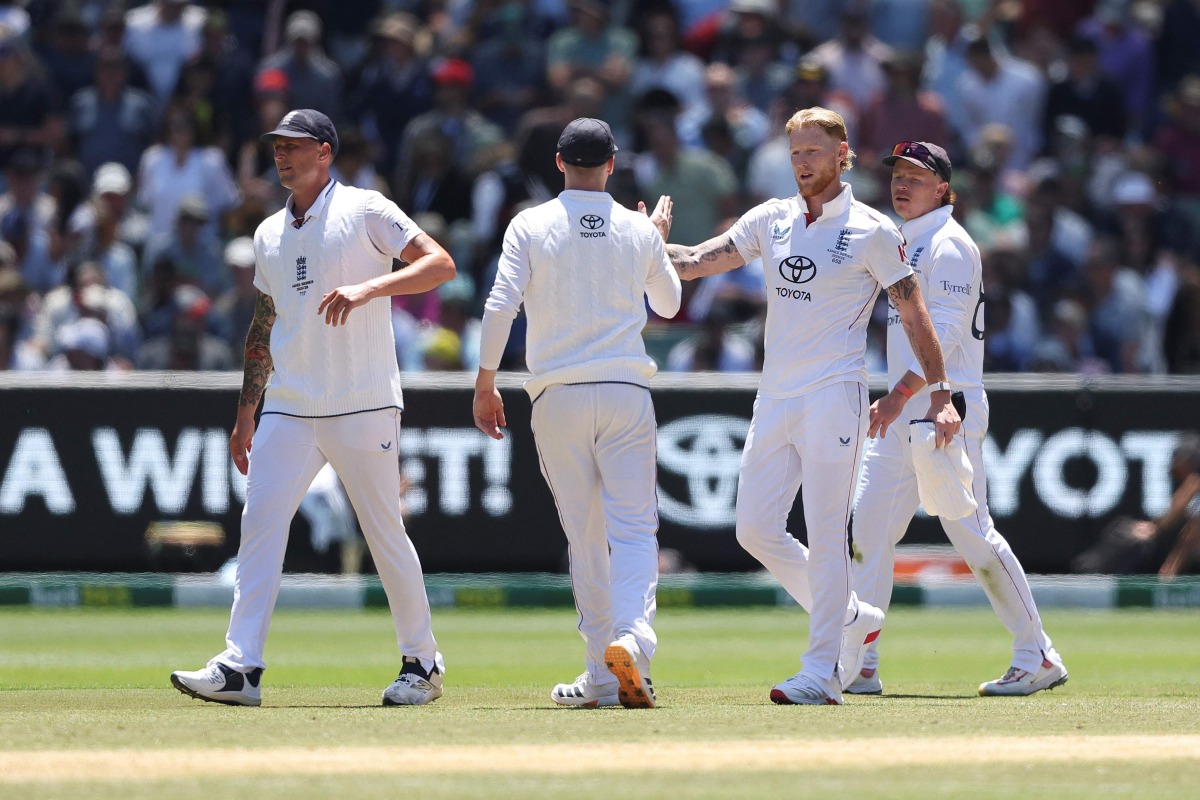 England’s Ben Stokes (second right) congratulates his teammates at the end of the innings during the second day at the Melbourne Cricket Ground. 