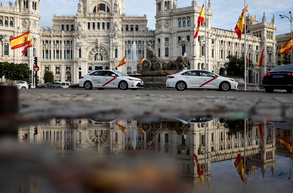 File: A picture taken on October 31, 2024 shows the Spanish flag flying at half-mast at the start of three days of national mourning after Spain's deadliest floods in decades, at Cibeles Square in Madrid. (Photo by Oscar Del Pozo / AFP)