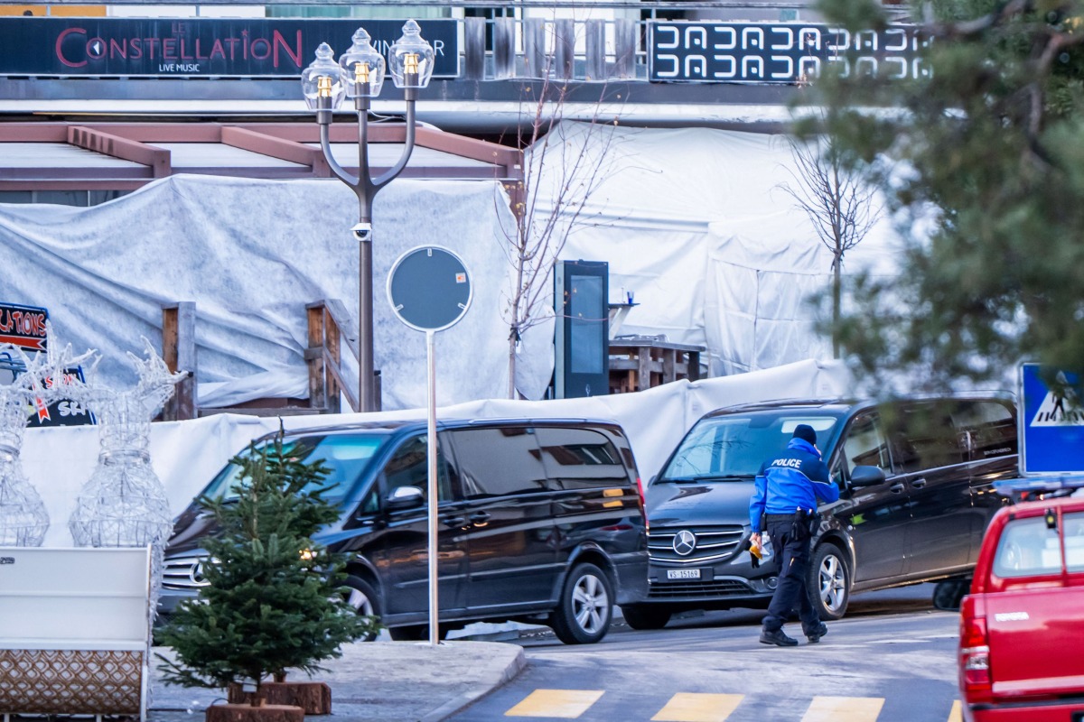 Funeral service vehicles arrive near the bar Le Constellation where a fire ripped through the venue during New Year's Eve celebrations in Crans-Montana, on January 1, 2026. Photo by MAXIME SCHMID / AFP