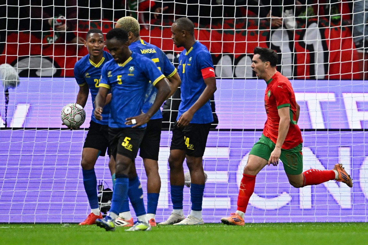 Morocco's forward #10 Brahim Diaz (R) celebrates scoring his team's first goal during the Africa Cup of Nations (CAN) round of 16 football match between Morocco and Tanzania at Prince Moulay Abdallah Stadium in Rabat on January 4, 2026. (Photo by Gabriel BOUYS / AFP)