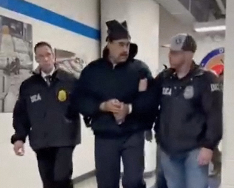 This screengrab taken from the X account of Rapid Response 47, the official White House rapid response account, shows Venezuelan President Nicolas Maduro (C) escorted by DEA agents inside the headquarters of the US Drug Enforcement Administration (DEA) in lower Manhattan, New York, on January 3, 2026. (Photo by X account of Rapid Response 47 / AFP)