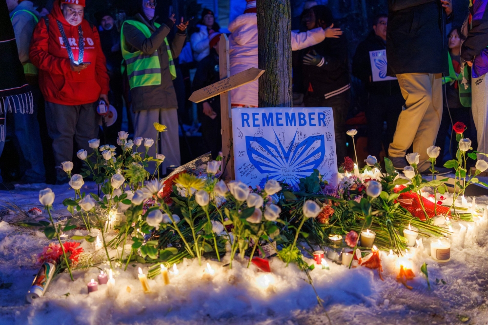 People demonstrate during a vigil at the site where a woman was shot and killed by an immigration officer earlier in the day in Minneapolis, Minnesota, on January 7, 2026. An immigration officer in Minneapolis shot dead a woman Wednesday. (Photo by Kerem Yucel/ AFP)
