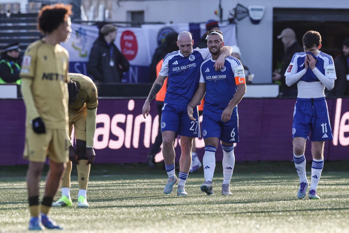 Macclesfield's English midfielder #27 Josh Kay (centre L) walks back with Macclesfield's English midfielder #06 Paul Dawson (centre R) after the latter scored the team's first goal during the English FA Cup third round football match between Macclesfield Town and Crystal Palace at Leasing.com Stadium, Moss Rose in Macclesfield, northern England on January 10, 2026. (Photo by Darren Staples / AFP) 