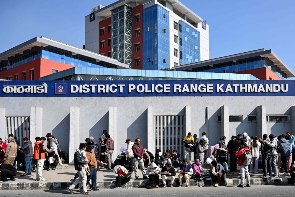 Nepali youth queue to submit applications for temporary police personnel for the upcoming general elections outside the District Police Range office in Kathmandu on January 11, 2026. (Photo by Prakash Mathema / AFP)