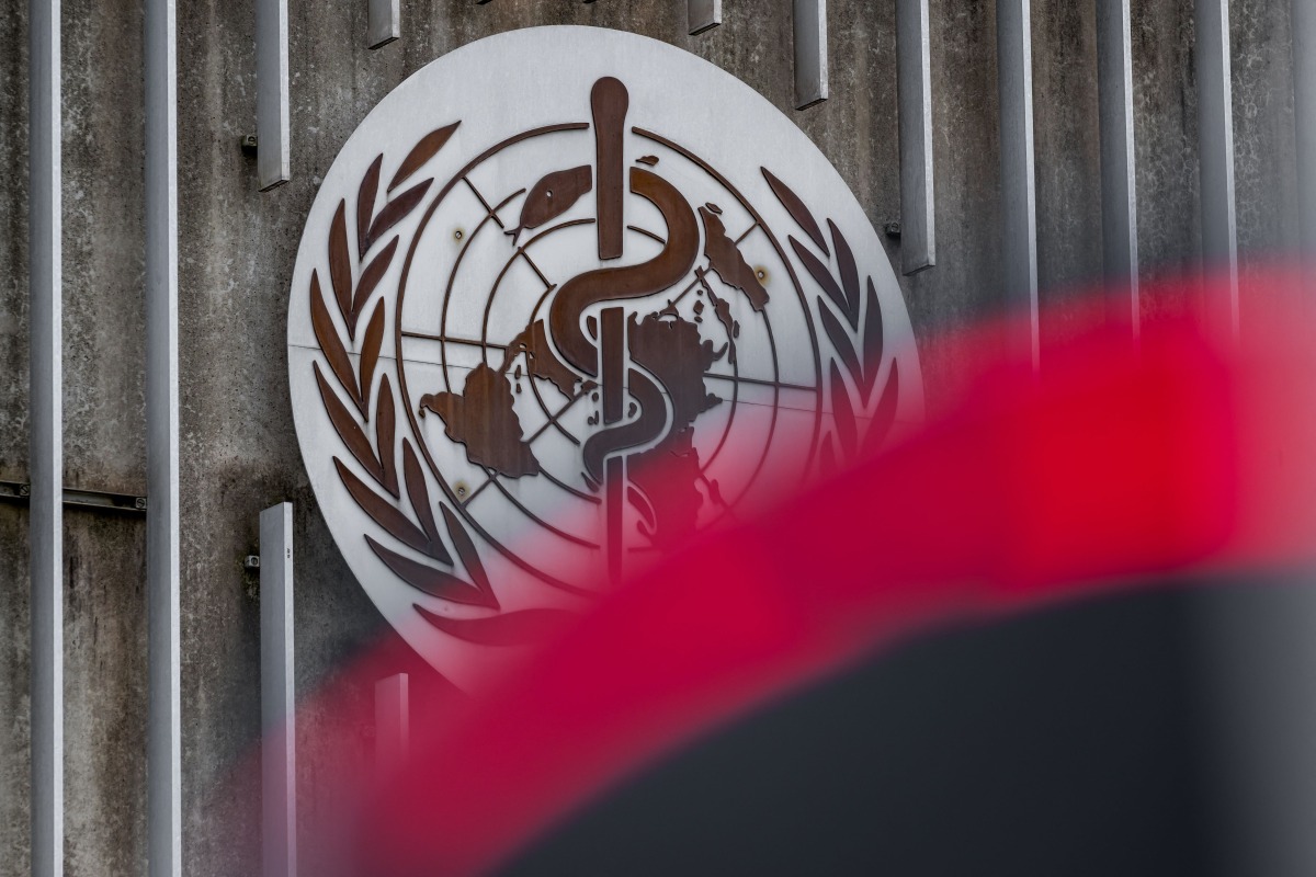 This photograph taken on April 23, 2025 shows a logo of the World Health Organisation (WHO) next to their headquarters in Geneva. Photo by Fabrice COFFRINI / AFP