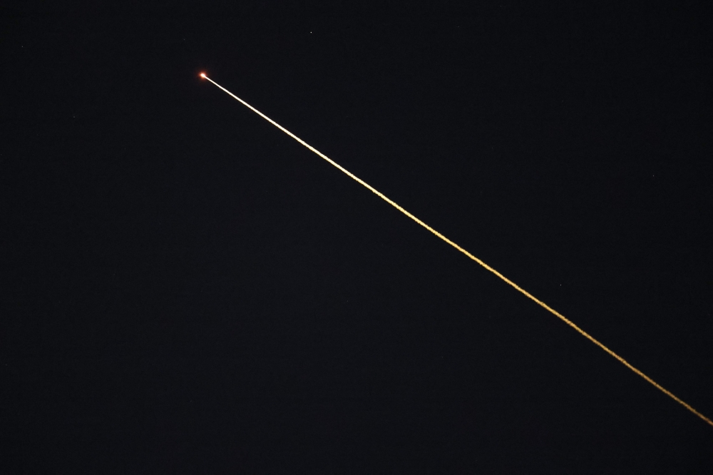 The SpaceX Dragon capsule Crew 11 returns early to Earth from space due to an astronaut's medical issue as seen during reentry over Los Angeles, California on January 15, 2026. (Photo by Patrick T. Fallon / AFP)