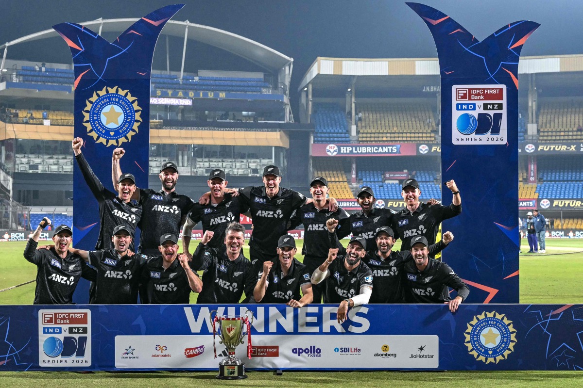 New Zealand's players celebrate with the trophy after winning the series and the third ODI cricket match between India and New Zealand at the Holkar cricket Stadium in Indore on January 18, 2026. (Photo by Indranil MUKHERJEE / AFP)