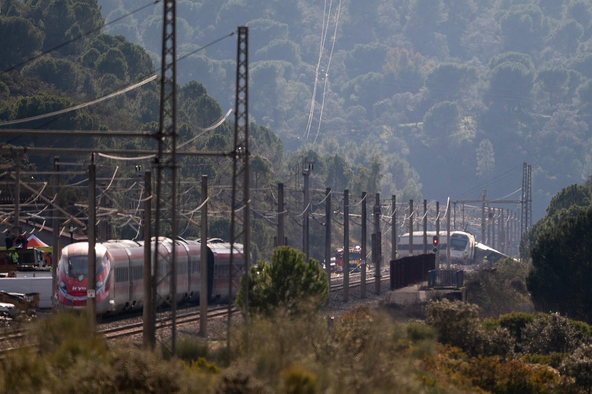Derailed trains are seen as rescue efforts continue at the site of a deadly train accident in Adamuz, southern Spain, on January 19, 2026.(Photo by JORGE GUERRERO / AFP)
