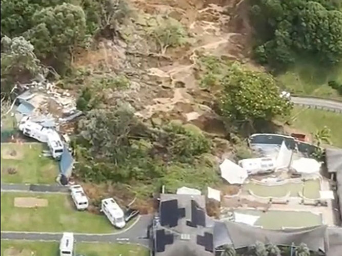 This screen grab made from UGC footage shows the site of a landslide in Mount Maunganui. A landslide smashed into a campsite in rain-swept northern New Zealand on January 22, leaving multiple people missing under tonnes of mud. (Photo by Handout / Amy Till, Solsea Swim / AFP) 