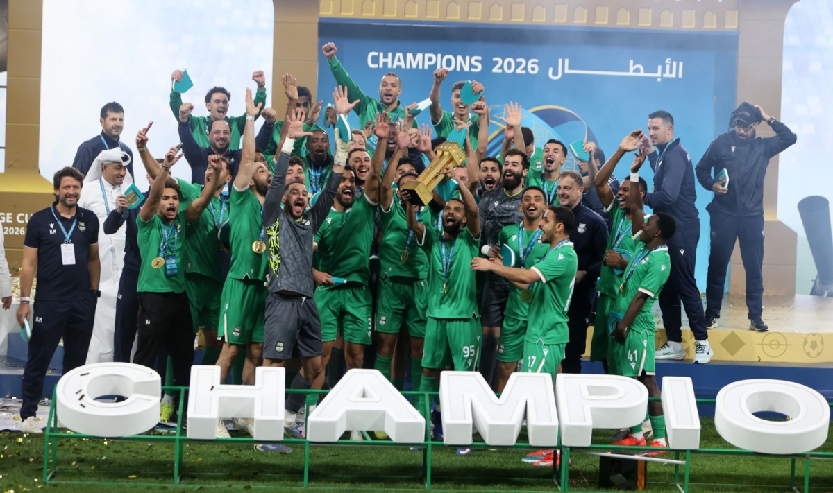 Al Ahli players and officials celebrate their victory.