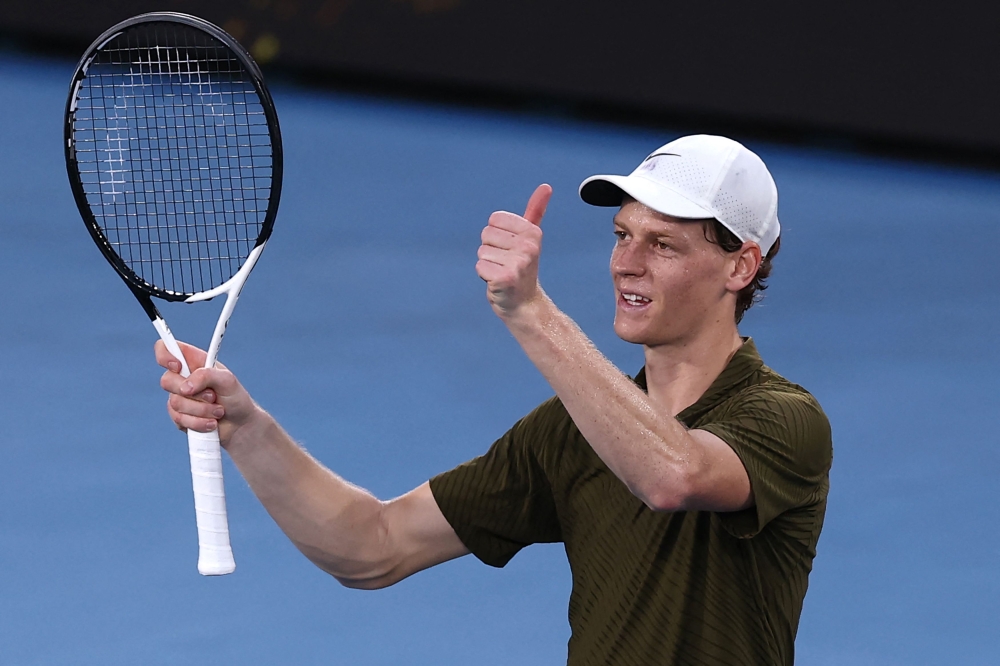 Italy's Jannik Sinner celebrates beating Italy's Luciano Darderi in their men's singles match on day nine of the Australian Open tennis tournament in Melbourne on January 26, 2026. (Photo by Izhar Khan / AFP)