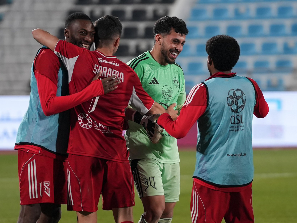 Al Arabi players celebrate their win over Qatar SC. 