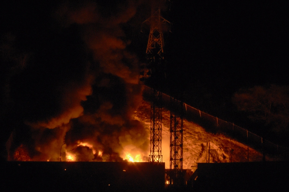 (Files) Picture of fire at Fuerte Tiuna, Venezuela's largest military complex, after a series of explosions in Caracas on January 3, 2026. (Photo by Luis Jaimes / AFP)