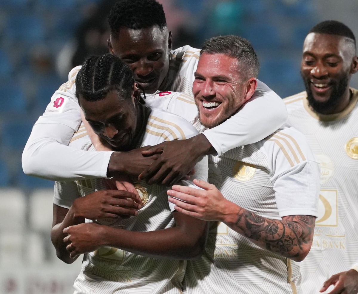 Al Arabi players celebrate during the match against Umm Salal.