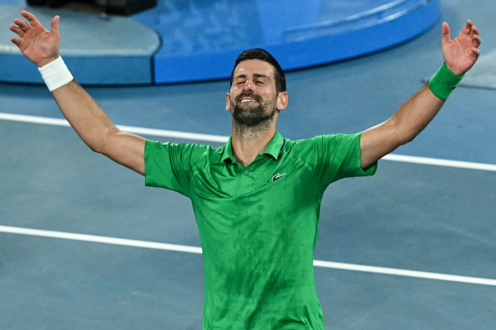 Serbia's Novak Djokovic celebrates victory over Italy's Jannik Sinner after their men's singles semi-final match on day thirteen of the Australian Open tennis tournament in Melbourne on January 31, 2026. (Photo by William West / AFP)