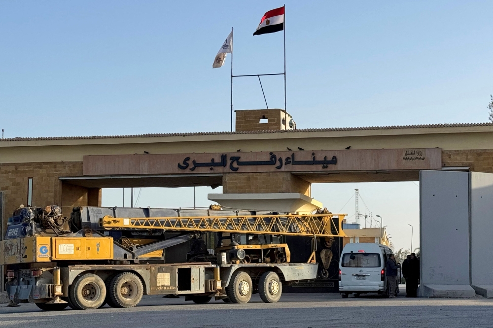 A construction crane enters through the Egyptian side of the Rafah border crossing with the Gaza Strip in northeastern Egypt on February 1, 2026. (Photo by AFP)
 