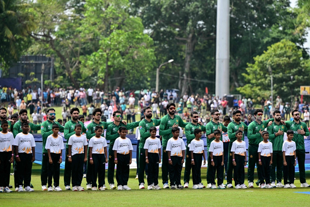 Pakistan players stand for the national anthem before the start of the 2026 ICC Men's T20 Cricket World Cup group stage match between Pakistan and Netherlands at the Sinhalese Sports Club (SSC) Ground in Colombo on February 7, 2026. (Photo by Ishara S.Kodikara / AFP)
 