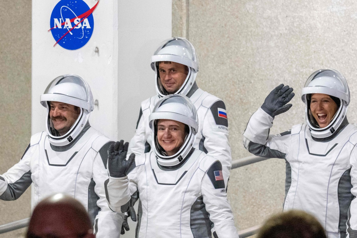 NASA astronauts Jessica Meir (C), commander, and Jack Hathaway (L), pilot, ESA (European Space Agency) astronaut Sophie Adenot (R), and Roscosmos cosmonaut Andrey Fedyaev (2ndL) walk out as they prepare to travel to the SpaceX Falcon 9 rocket with the company's Dragon spacecraft at Space Launch Complex 40 for the Crew-12 mission at Cape Canaveral Space Force Station in Florida, on February 13, 2026. (Photo by Jim WATSON / AFP)