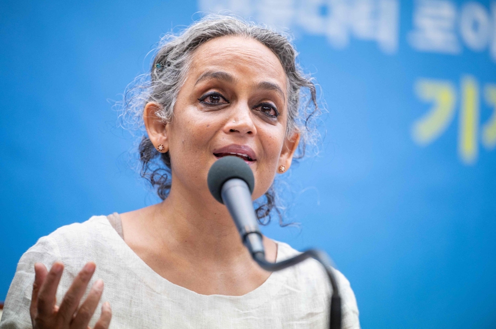 (Files) Indian author Arundhati Roy speaks during a press conference in Seoul on November 25, 2021. (Photo by Anthony Wallace / AFP)