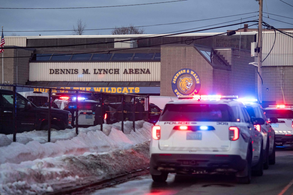 Police stand outside the perimeter they created around the Dennis M. Lynch Arena where a shooting occurred earlier today in Pawtucket, Rhode Island, on February 16, 2026. Photo by Joseph Prezioso / AFP