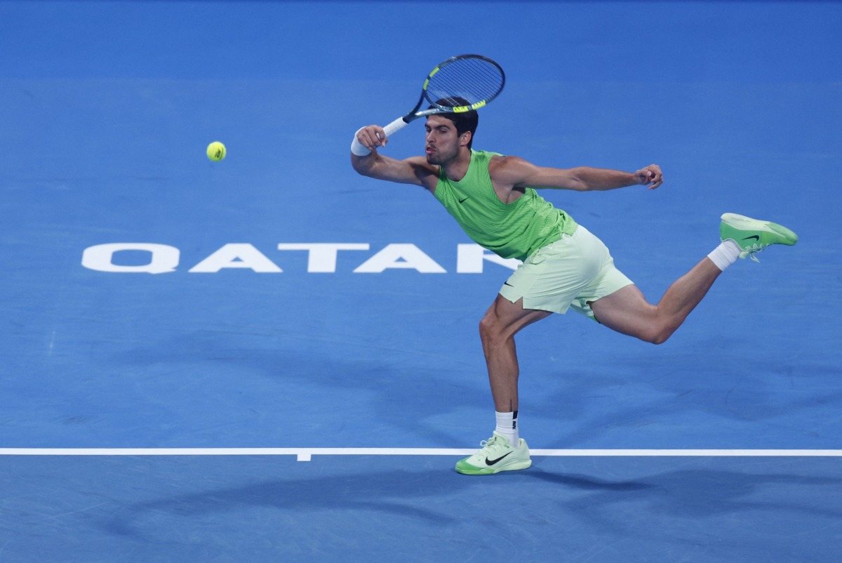 Spain's Carlos Alcaraz hits a return against France’s Arthur Rinderknech during their men's singles match in Doha yesterday. AFP