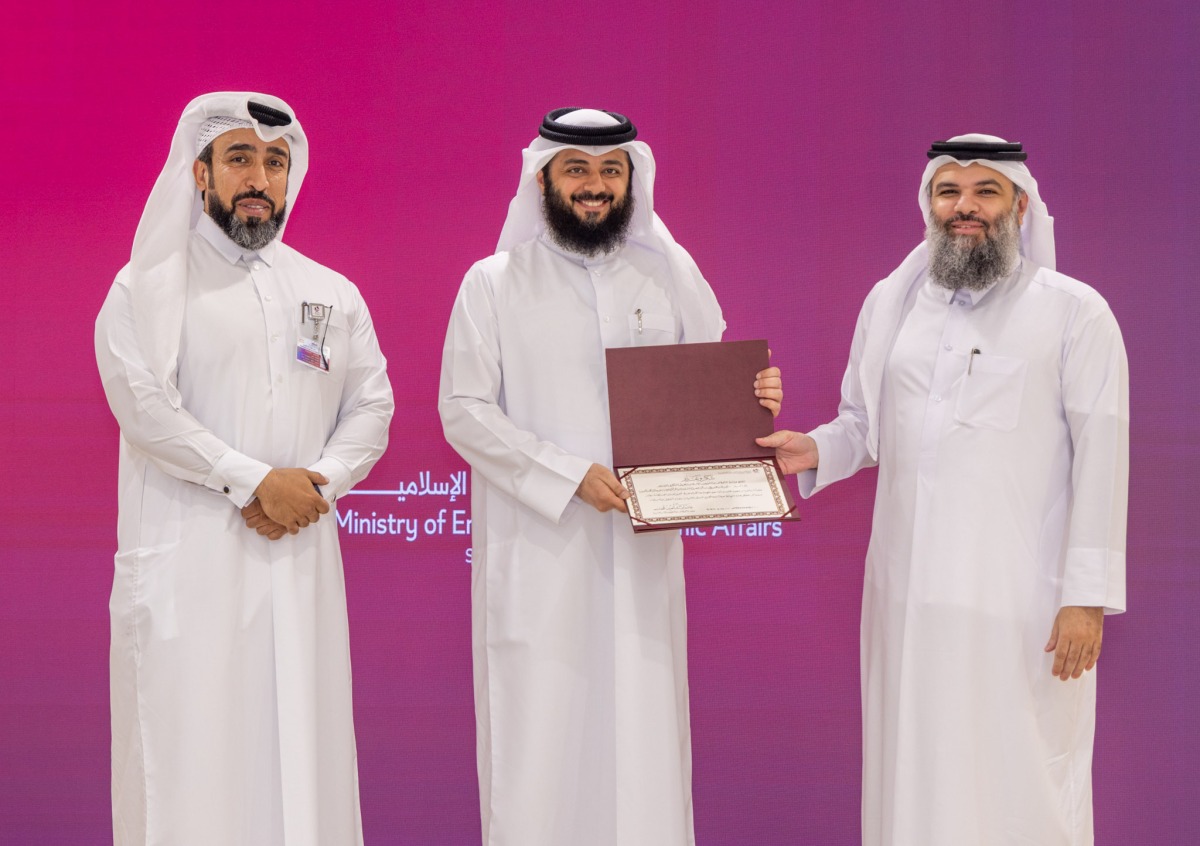 Undersecretary of the Ministry of Awqaf and Islamic Affairs H E Dr. Sheikh Khalid bin Mohammed bin Ghanem Al Thani honouring a winner.