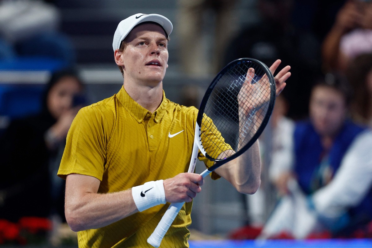 Italy's Jannik Sinner greets the fans after defeating Australia's Alexei Popyrin in their men singles match at the Qatar Open tennis tournament in Doha on February 18, 2026. (Photo by Karim JAAFAR / AFP)