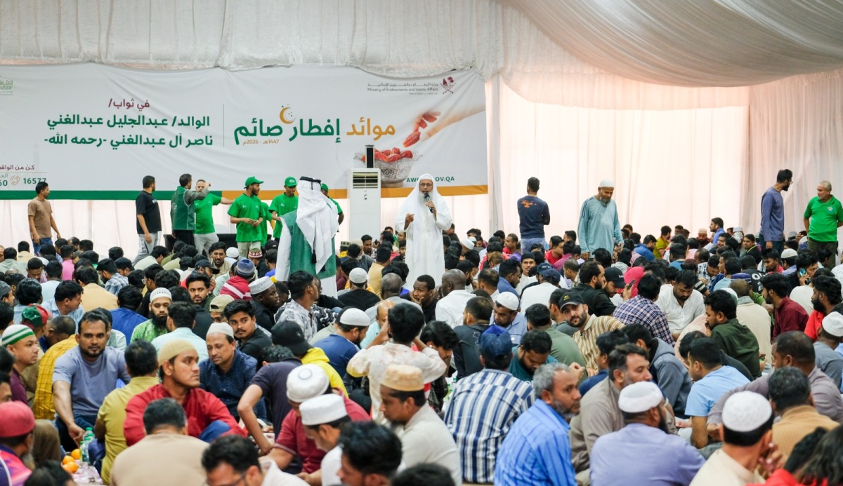 People gather to break their fasts at a tent organised by the Ministry of Awqaf. 