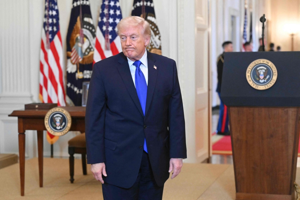 US President Donald Trump reacts as he departs during the Angel Families Remembrance Ceremony in the East Room of the White House in Washington, DC, on February 23, 2026. (Photo by Saul Loeb / AFP)