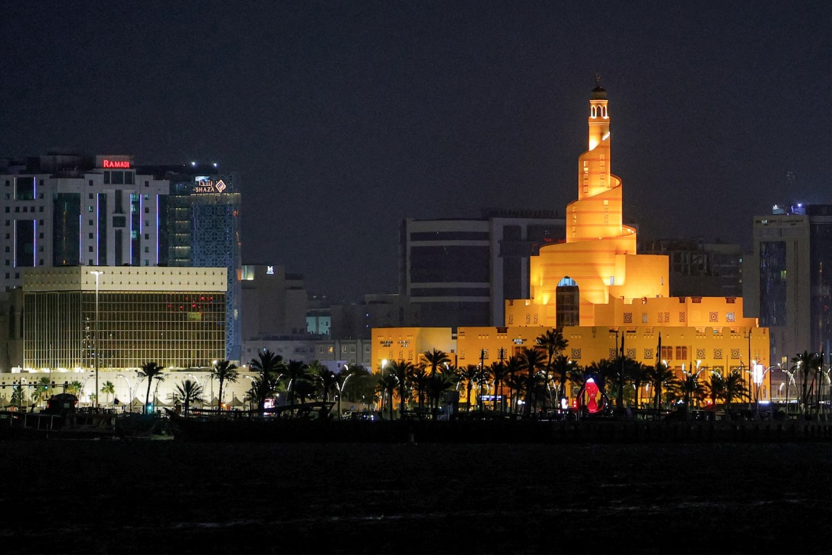 The illuminated Abdulla Bin Zaid al-Mahmud Islamic Cultural Center, also known as Fanar Mosque with the spiral-shaped minaret, is pictured at night in Doha on March 1, 2026. Photo by Karim Jaafar / AFP