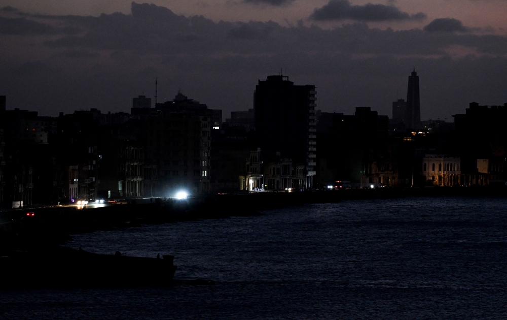 A view of buildings during a blackout in Havana taken on March 4, 2026. (Photo by Yamil Lage / AFP)