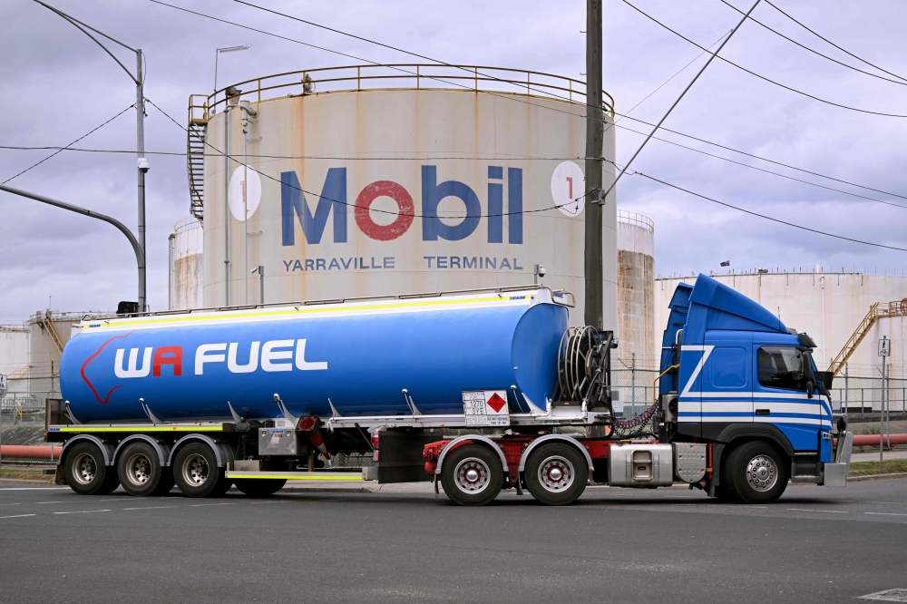 A fuel tanker passes the Mobil fuel distribution centre in the Melbourne suburb of Yarraville on March 12, 2026 as the demands and prices of petrol and diesel soar due to the Middle East conflict.  (Photo by William West / AFP)