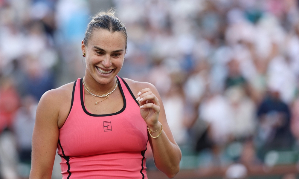 Aryna Sabalenka celebrates match point against Linda Noskova of Czech Republic during their Women's Singles Semifinals match. (Photo by Clive Brunskill/AFP)