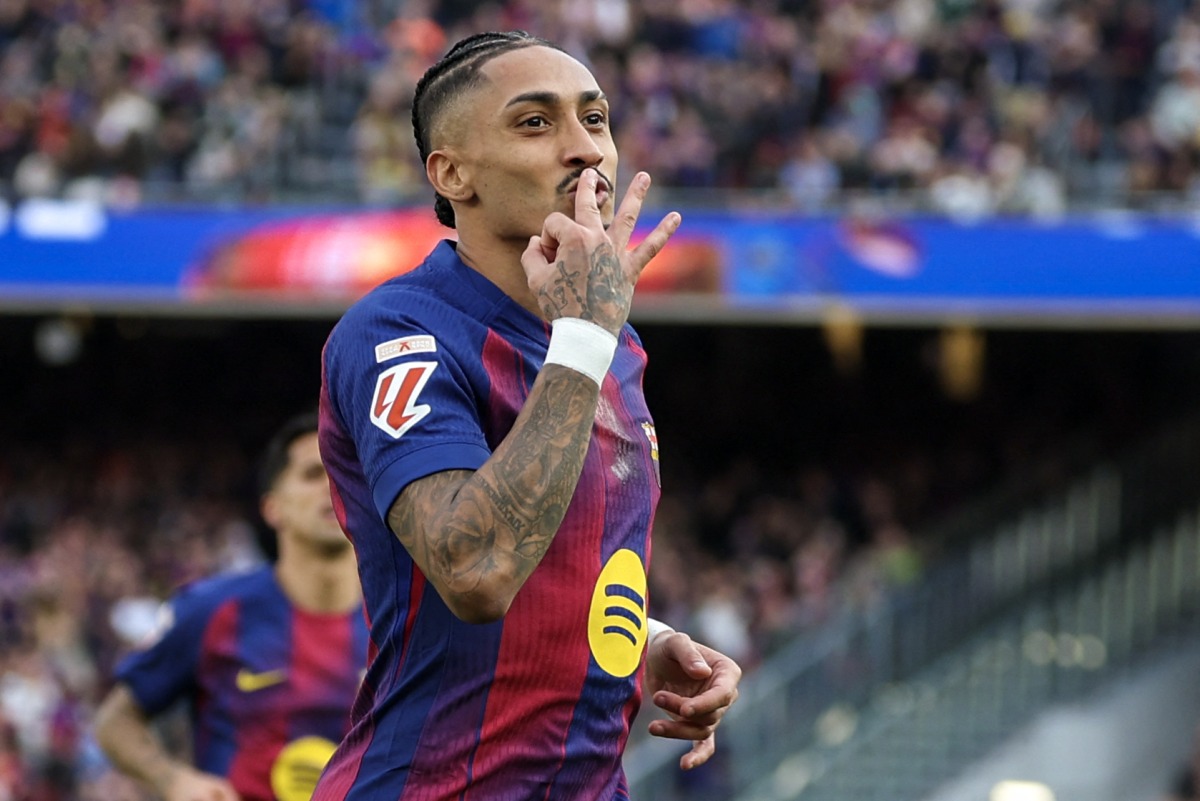 Barcelona's Brazilian forward #11 Raphinha celebrates scoring his team's fourth goal and his hat-tick, during the Spanish League football match between FC Barcelona and Sevilla FC at the Camp Nou Stadium in Barcelona, on March 15, 2026. (Photo by Lluis GENE / AFP)
