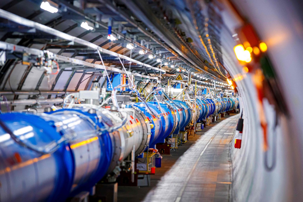 TOSome of the 1232 dipole magnets that bend the path of accelerated protons are pictured in the Large Hadron Collider (LHC) in a tunnel of the European Organisation for Nuclear Research (CERN), during maintenance works on February 6, 2020 in Echenevex, France, near Geneva. Photo by VALENTIN FLAURAUD / AFP