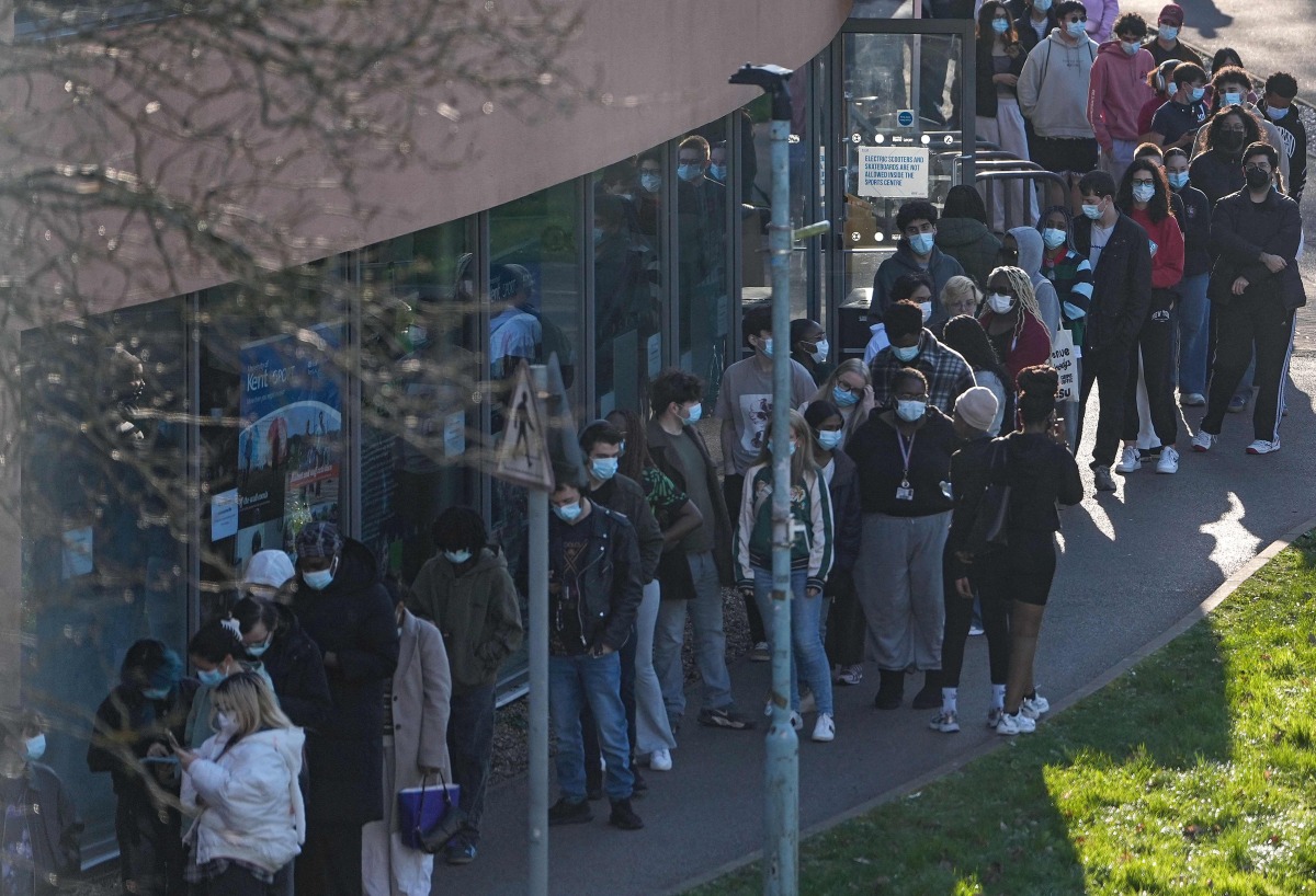 Students wearing face masks queue up to get vaccinated at the University of Kent in Canterbury, south-east England on March 18, 2026, following an outbreak of meningitis. Photo by CARLOS JASSO / AFP