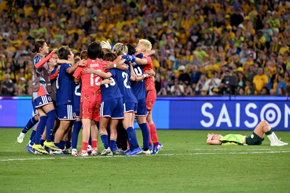 Japan's players celebrate winning the final of the AFC Women Asian Cup Australia 2026 football tournament between Australia and Japan at Stadium Australia in Sydney on March 21, 2026. (Photo by Saeed Khan / AFP)