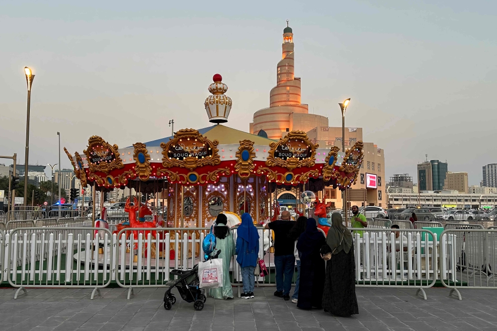 Families mark the second day of Eid al-Fitr at Doha Corniche, Souq Waqif, and Al Masrah park in Qatar. Photos by AFP