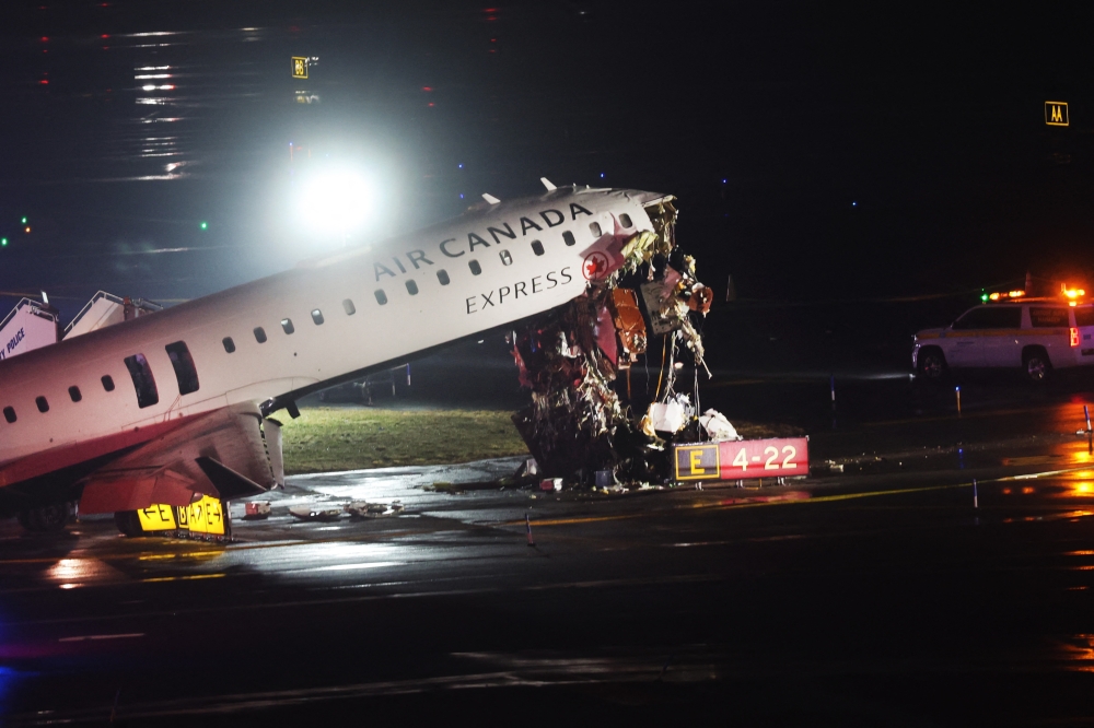 An Air Canada Express plane sits on the tarmac after it collided with a fire truck on the tarmac at LaGuardia Airport on March 23, 2026 in New York City. The plane had landed from a flight from Montreal. Spencer Platt/Getty Images/AFP 