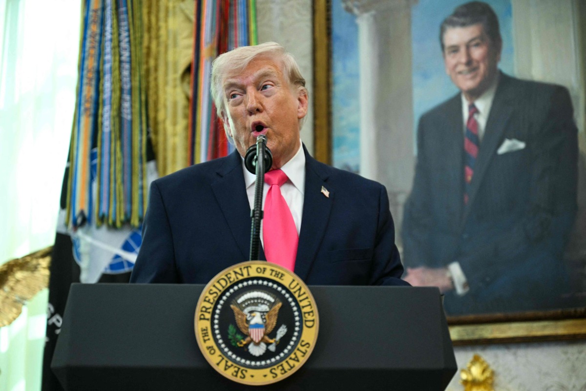 US President Donald Trump speaks before swearing in the new Secretary of Homeland Security Markwayne Mullin in the Oval Office of the White House in Washington, DC, on March 24, 2026. (Photo by Jim WATSON / AFP)
